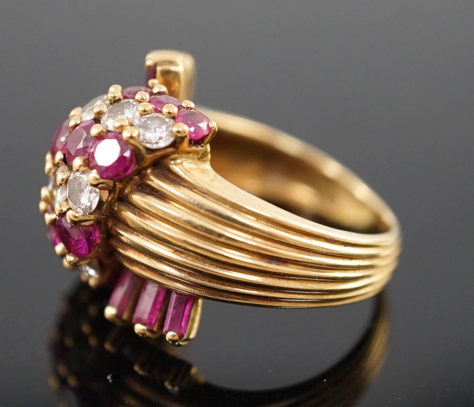 An early 1960's Kutchinsky 18ct gold ruby and diamond cluster set dress ring